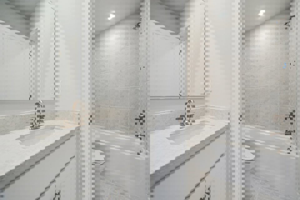 A bathroom with a tub sink and toilet.