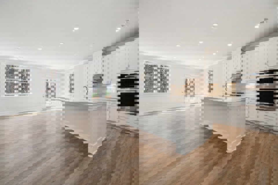 A kitchen with white cabinets.