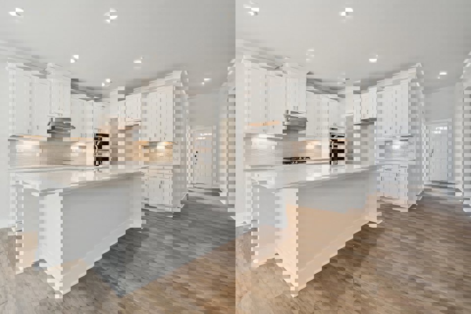 A kitchen with white cabinets.