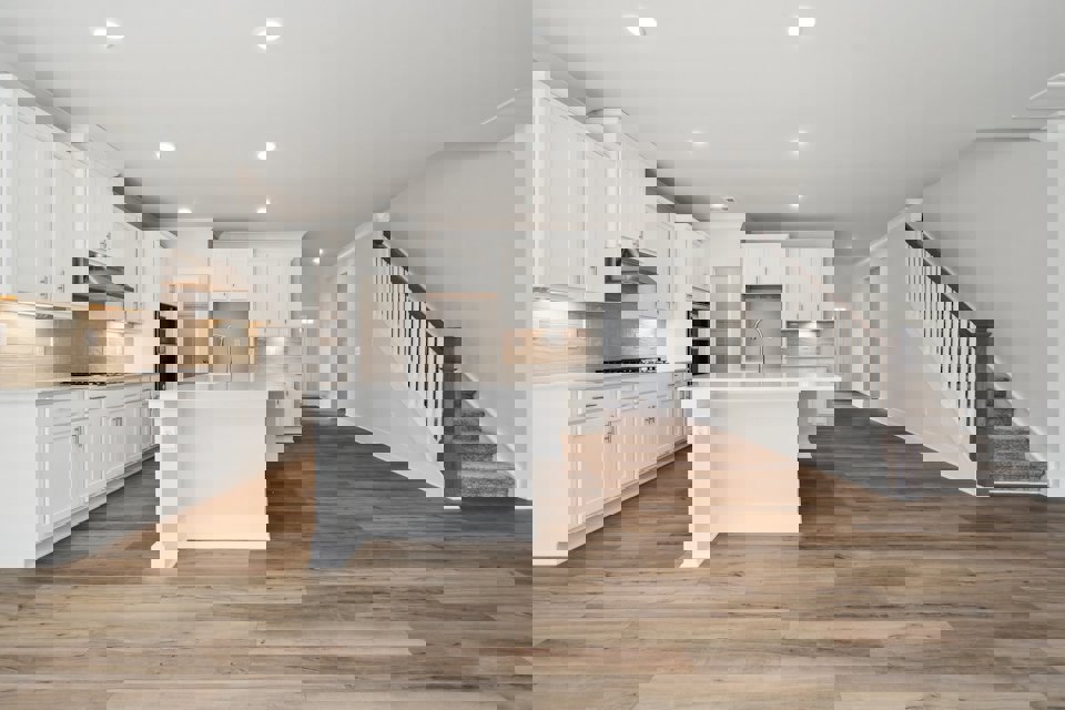 A kitchen with white cabinets.