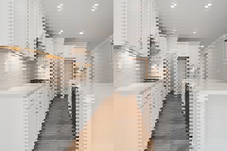 A kitchen with white cabinets.