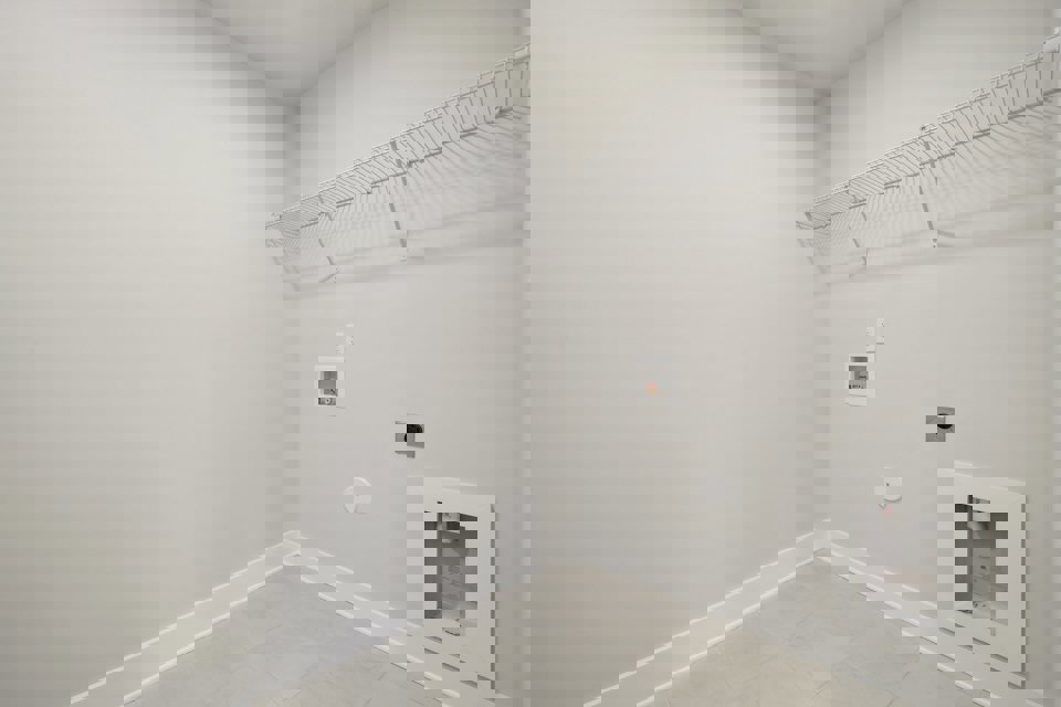 A white wall with a vent.