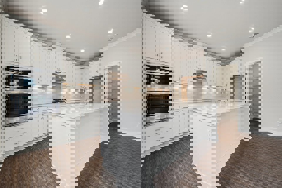 A kitchen with white cabinets.