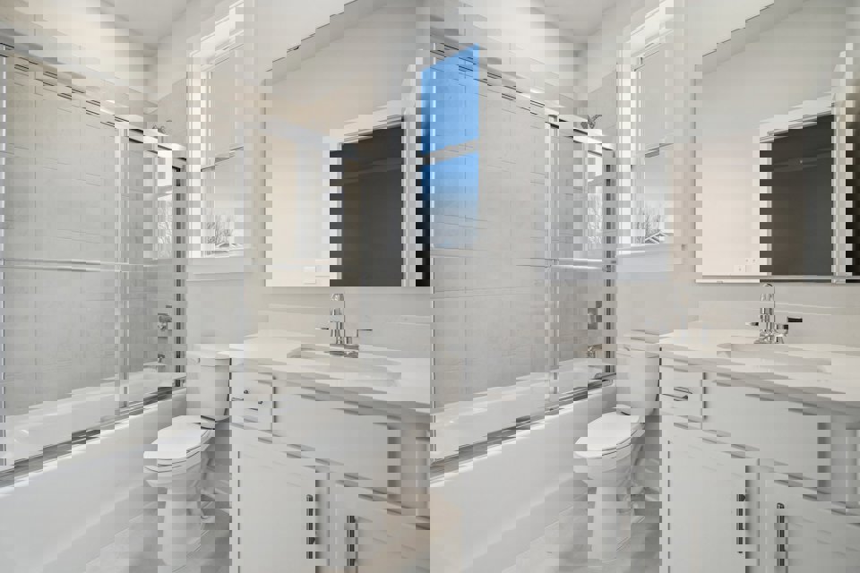 A bathroom with a tub toilet and sink.