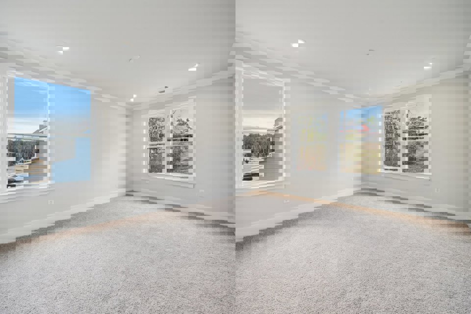 A room with a window and a carpet.