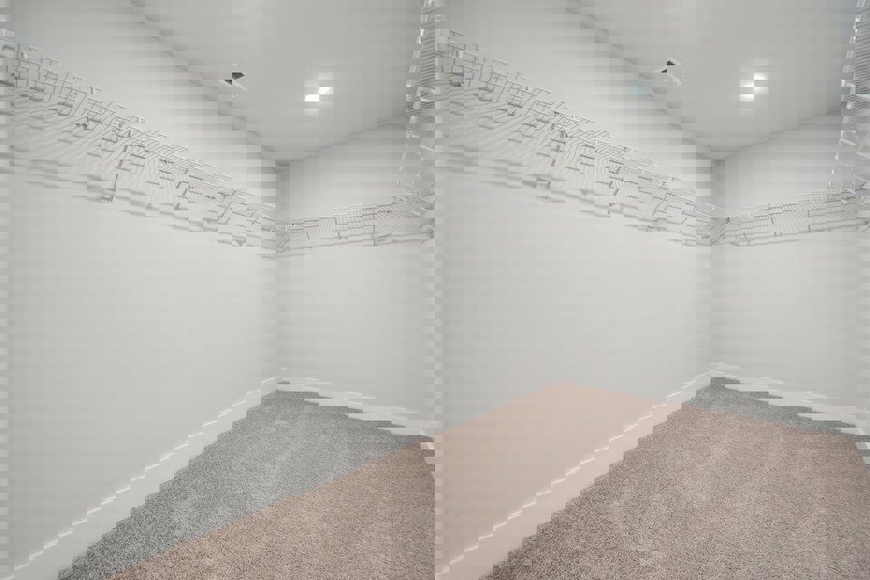 A white room with a carpet.