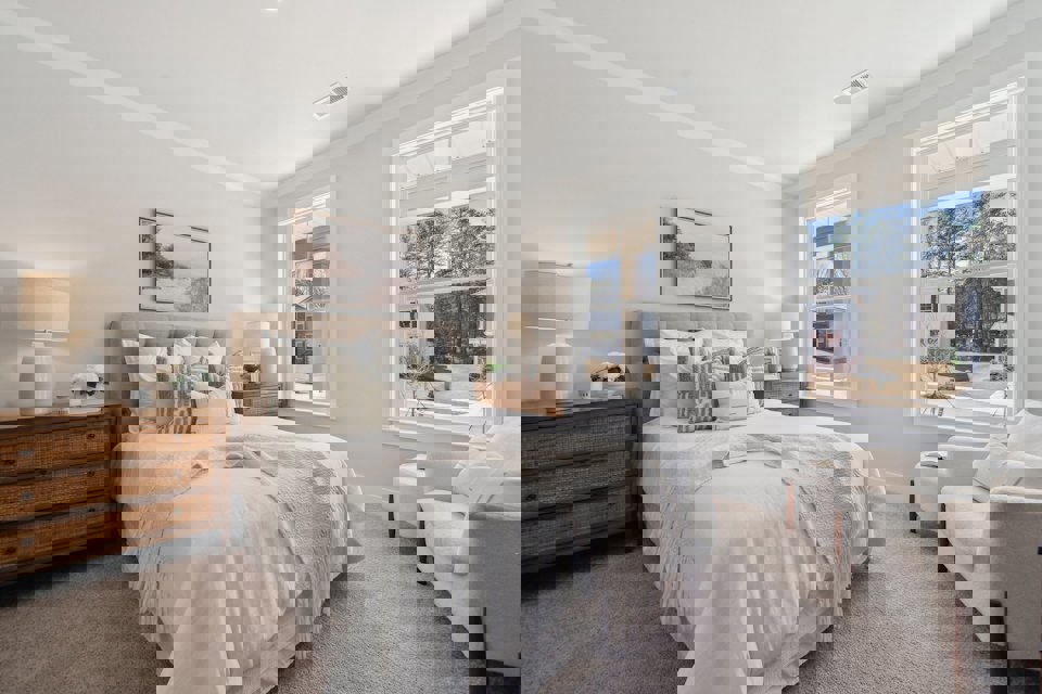 A bedroom with a large window.