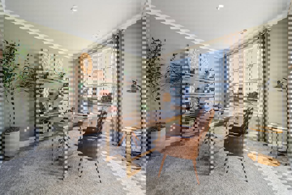 A living room with a table and chairs.