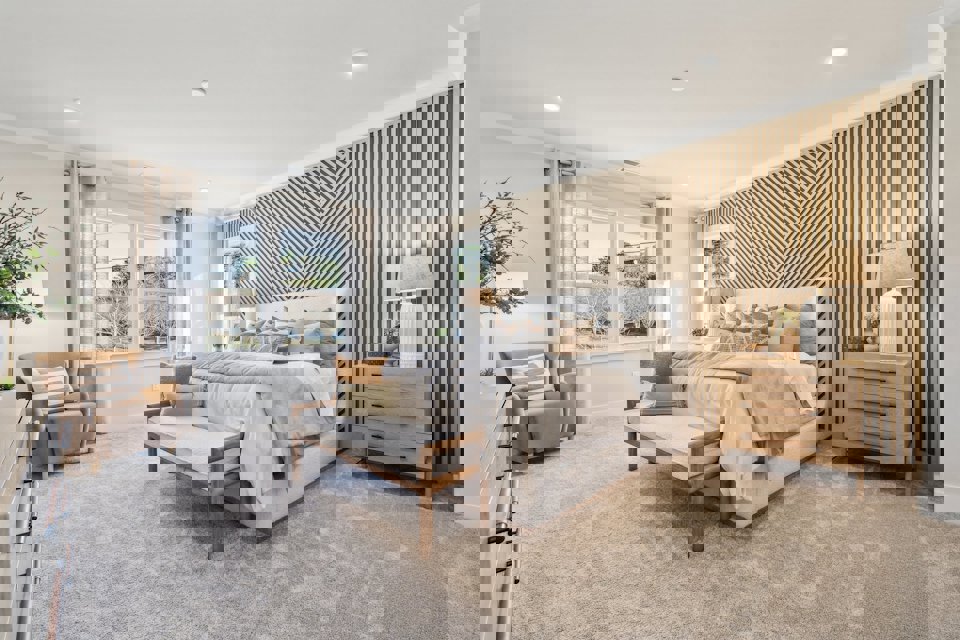 A bedroom with a bed and a bench.