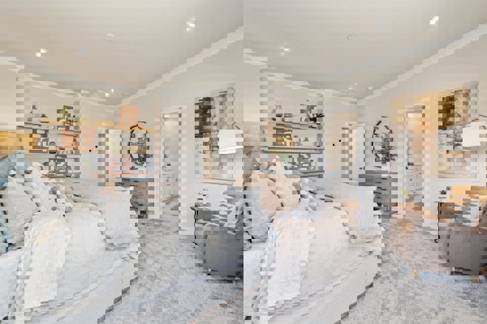 A bedroom with a bed and a chair.