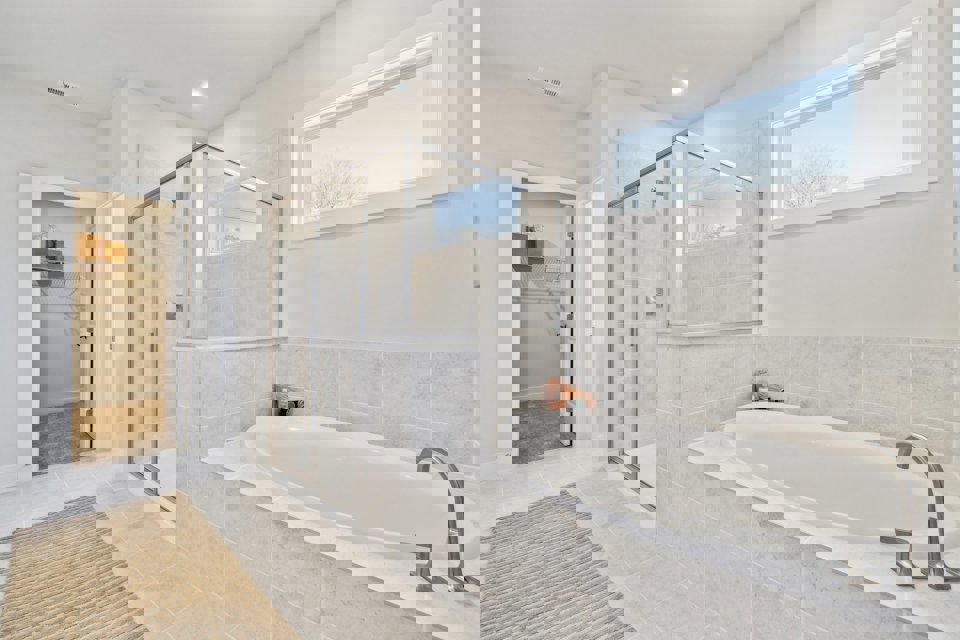 A bathroom with a tub and shower.