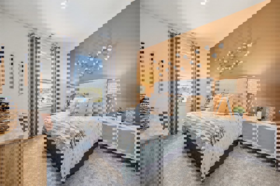 A bedroom with a bed and a window.