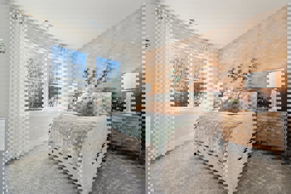 A bedroom with a bed and a dresser.