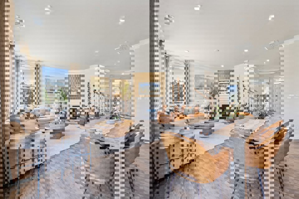 A large living room with a large dining table and chairs.