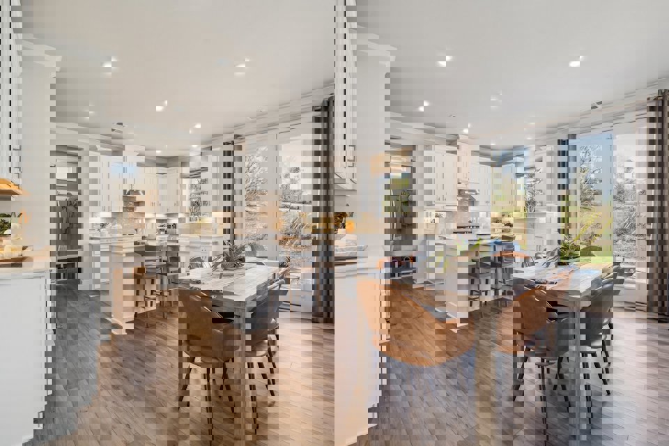 A kitchen with a dining table.