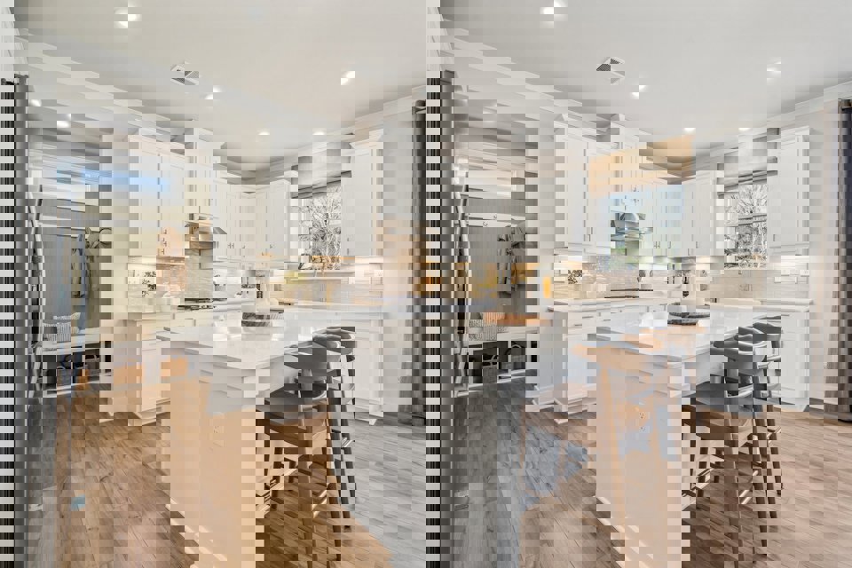 A kitchen with white cabinets.