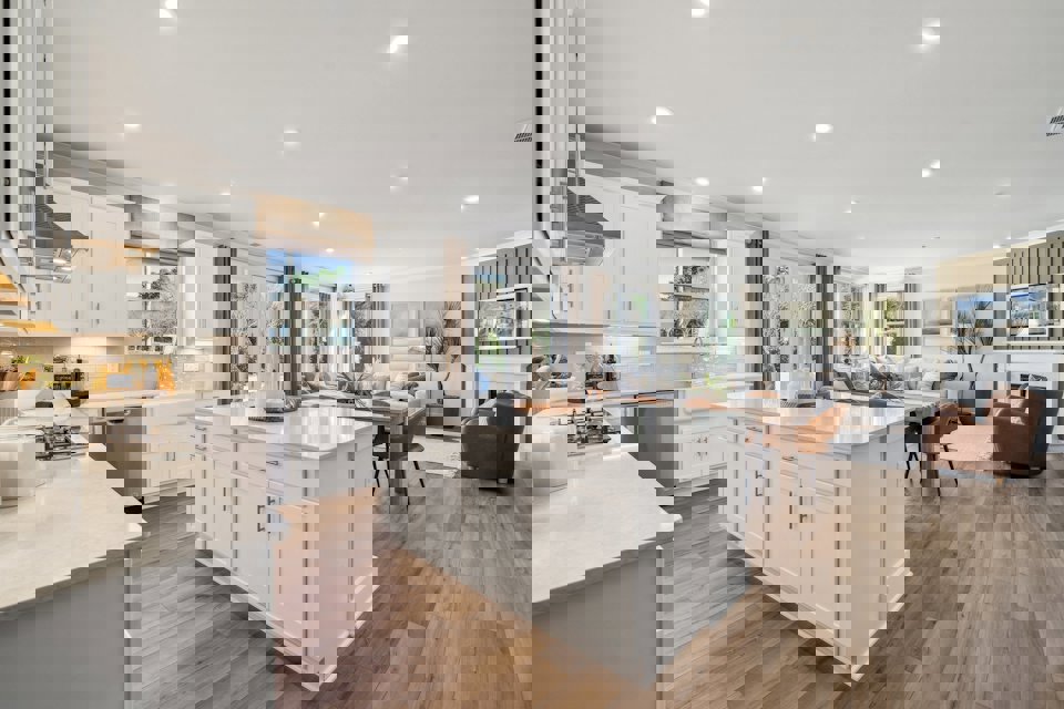 A kitchen with white cabinets.