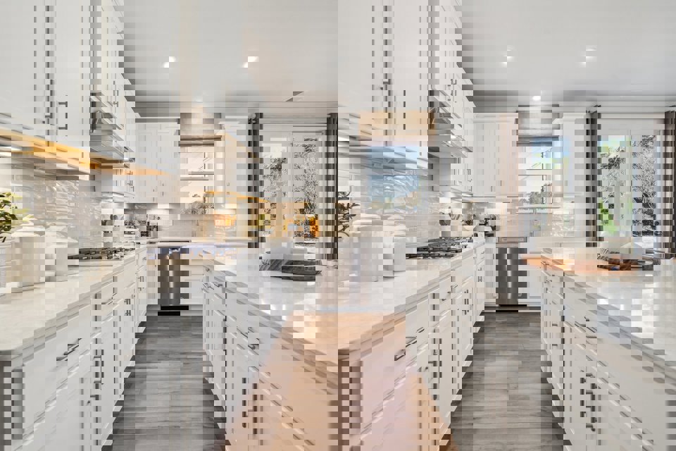 A kitchen with white cabinets.