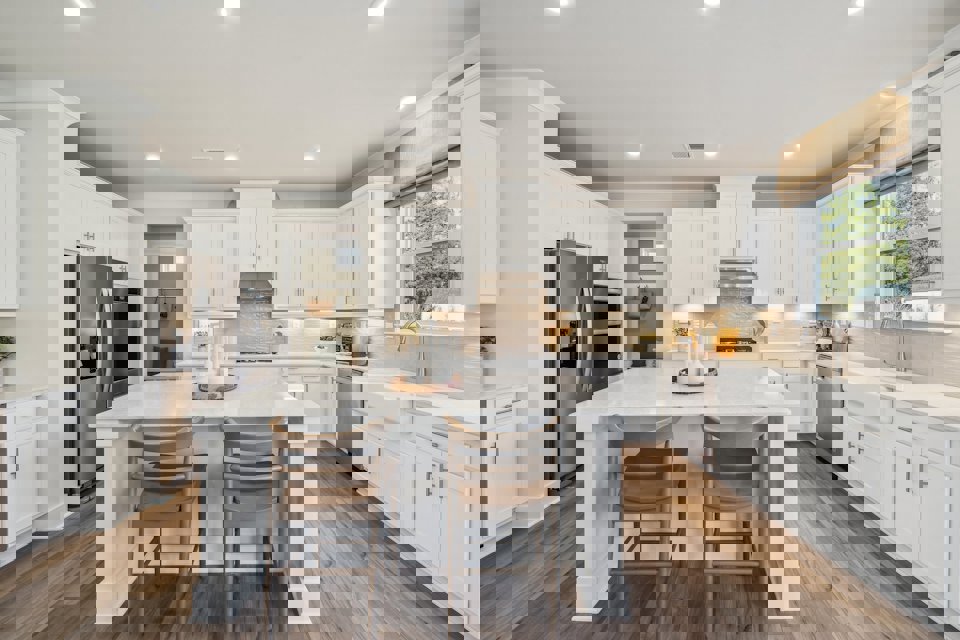 A kitchen with white cabinets.