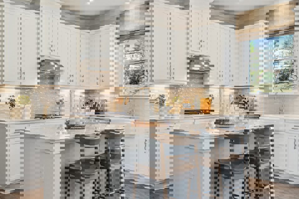 A kitchen with white cabinets.