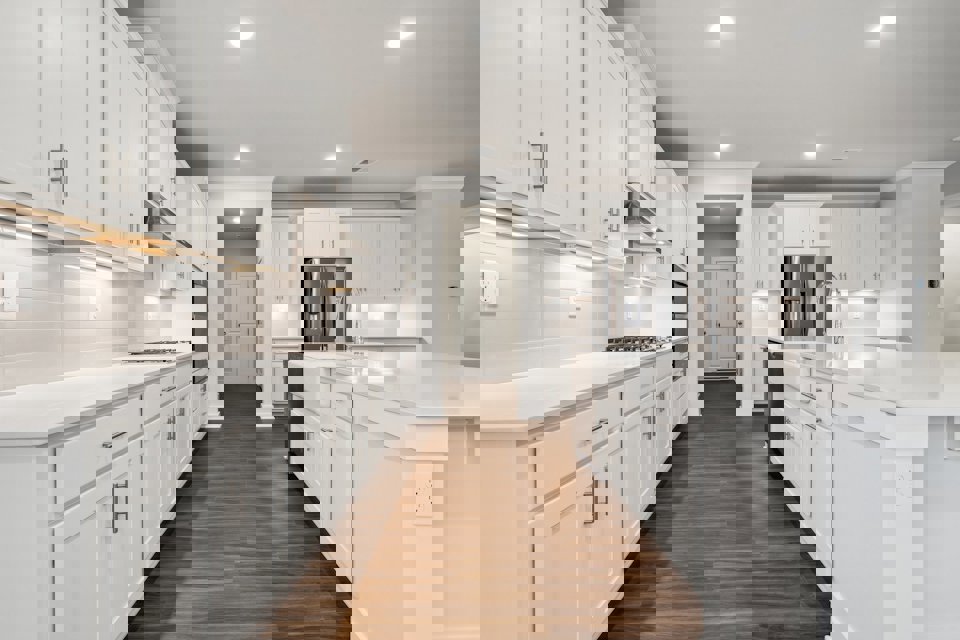 A kitchen with white cabinets.