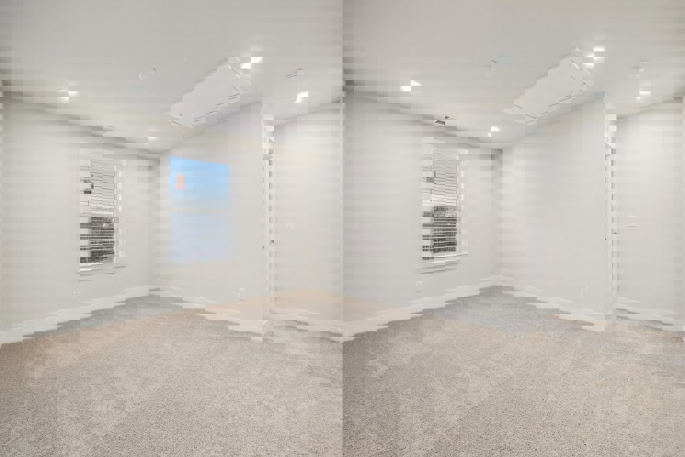 A room with a window and a carpet.