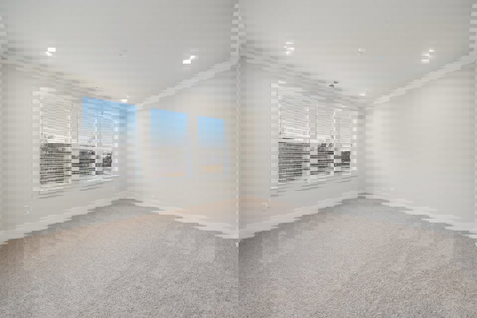 A room with a window and a carpet.