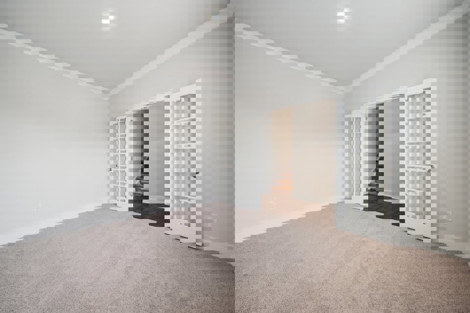 A room with a staircase and a door.