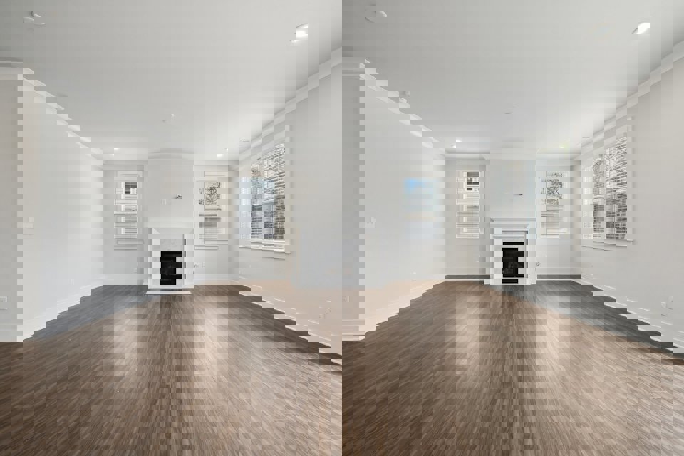 A large empty room with a fireplace.