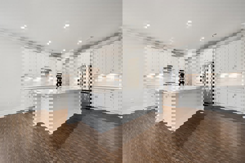 A kitchen with white cabinets.