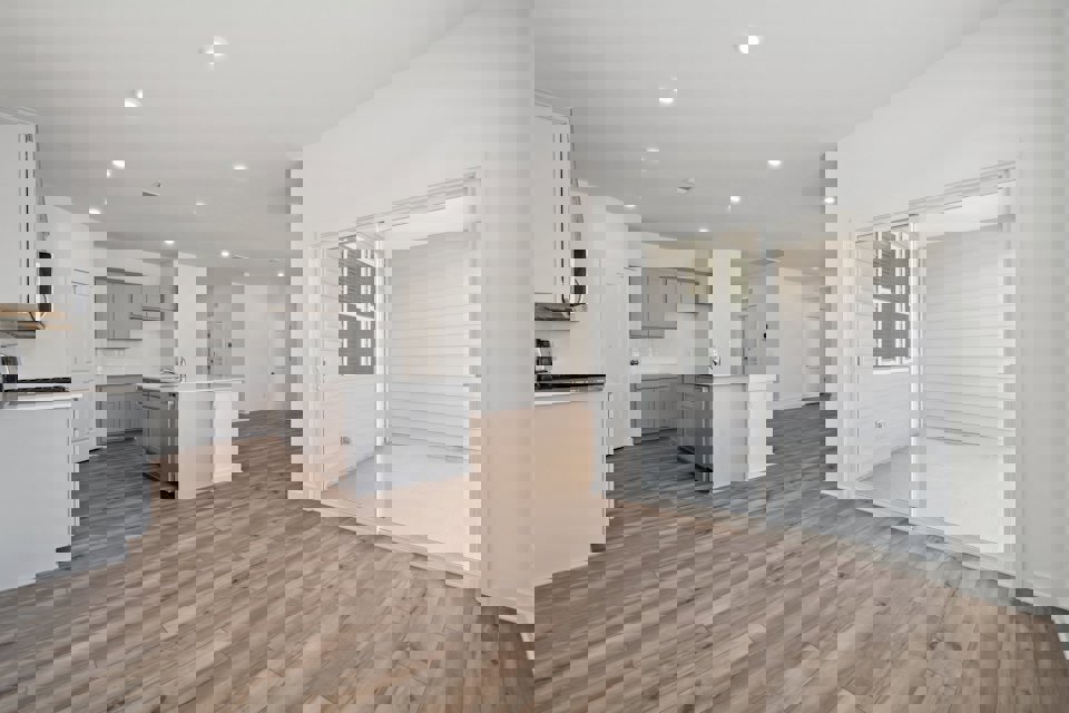 A large kitchen with white cabinets.