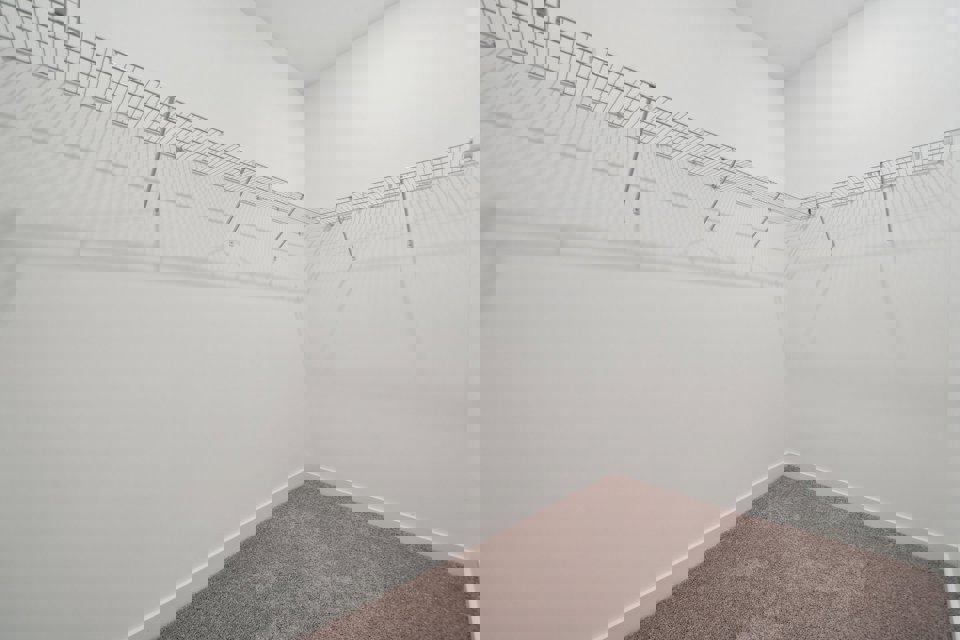 A white wall with a carpet.