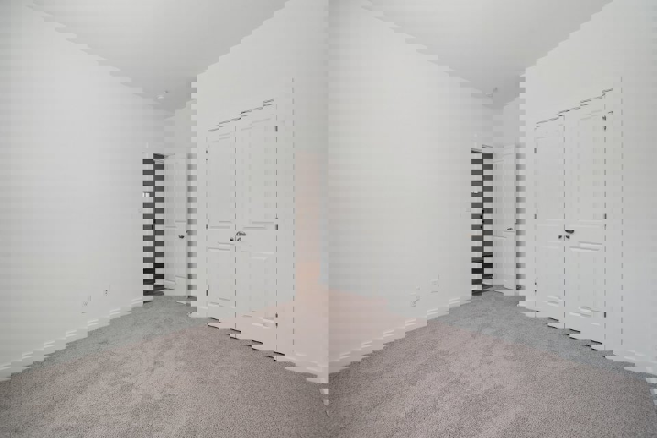 A hallway with white doors.