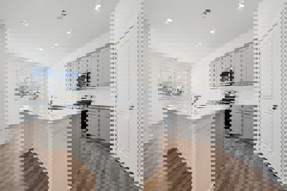 A kitchen with white cabinets.