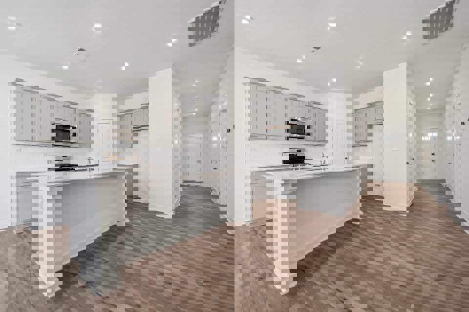 A kitchen with white cabinets.