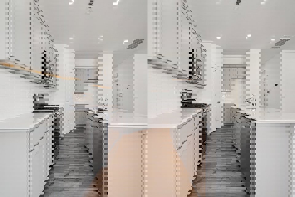 A kitchen with white cabinets.