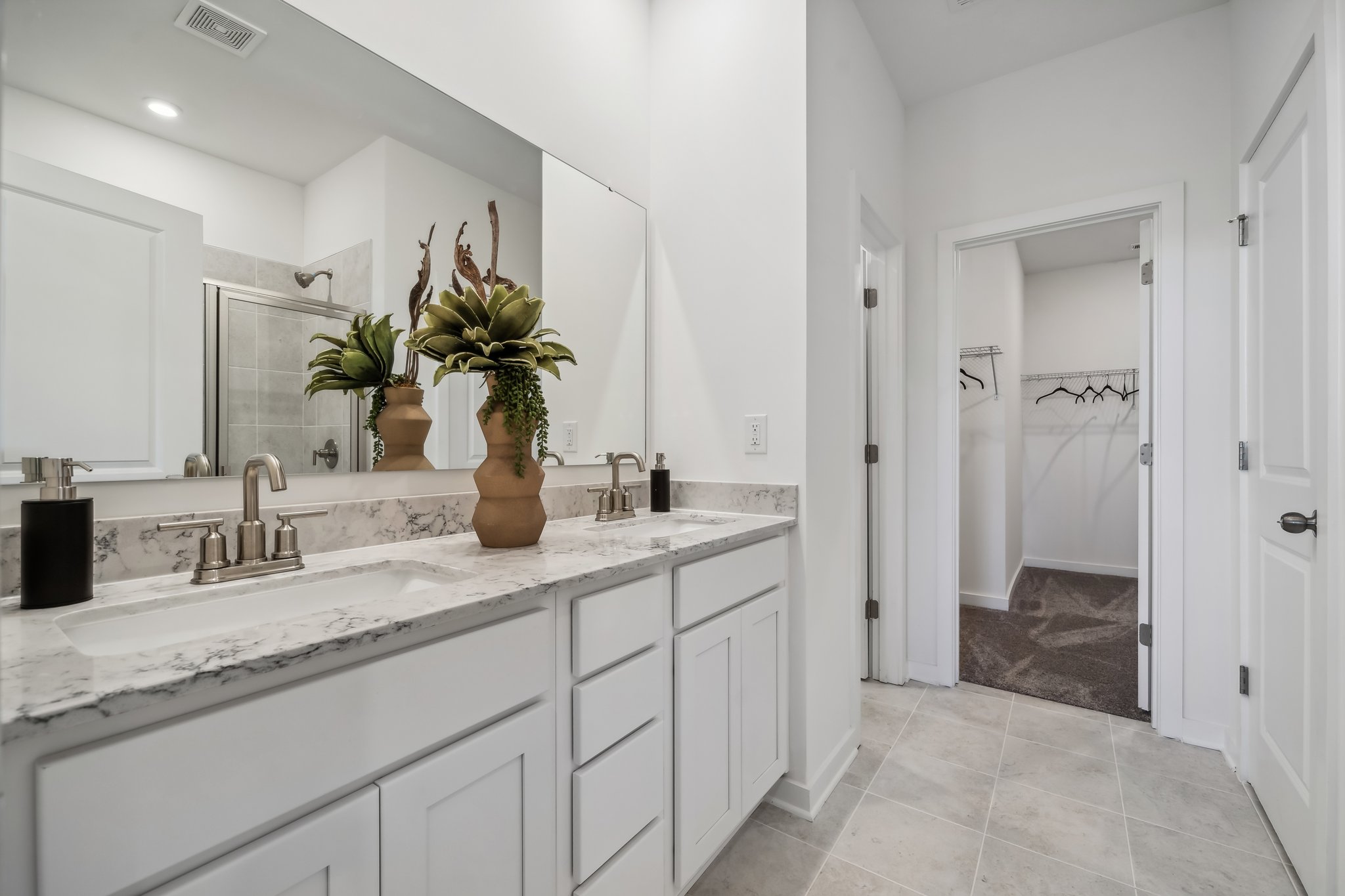 A bathroom with a sink and a shower.