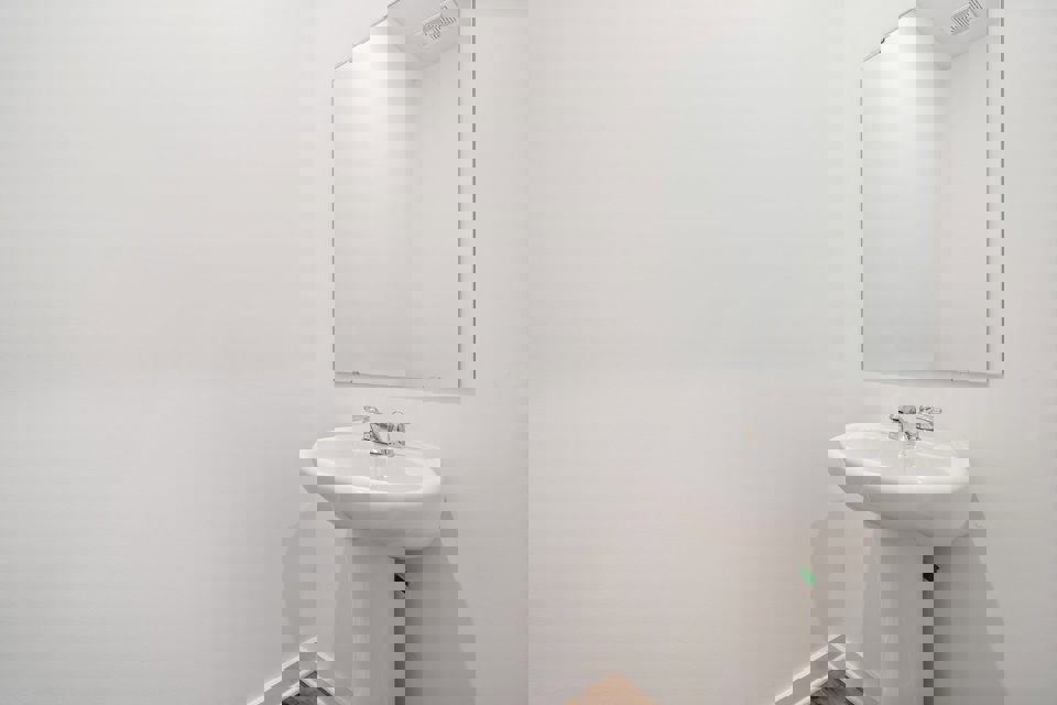 A bathroom with a mirror and sink.