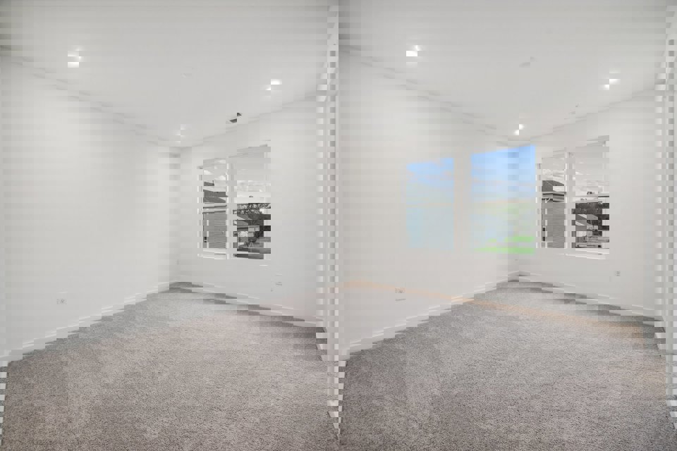 A room with a window and a carpet.