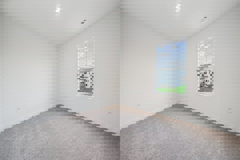 A room with a window and a carpet.