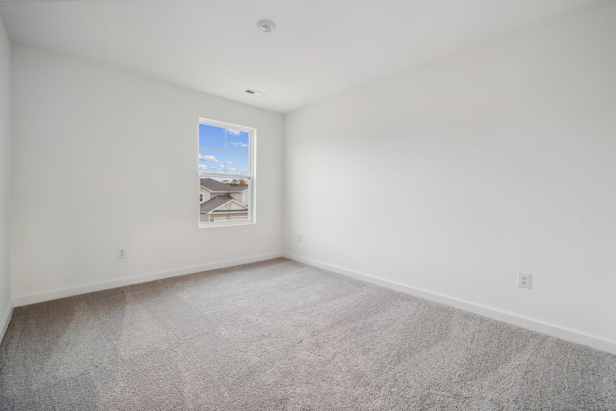 A room with a window and a shelf with a window.