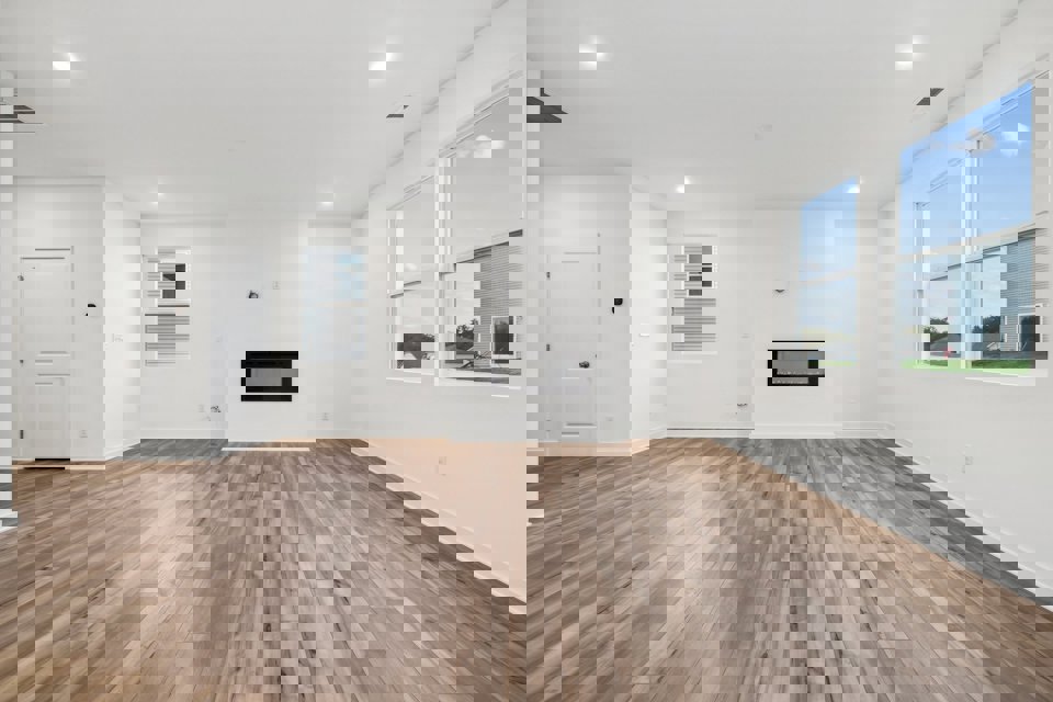 A room with a wood floor and a wood floor with a window.