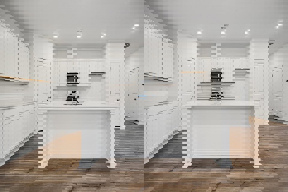 A kitchen with white cabinets.