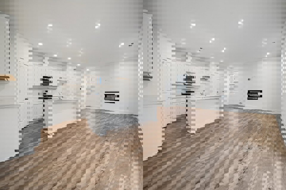 A kitchen with white cabinets.