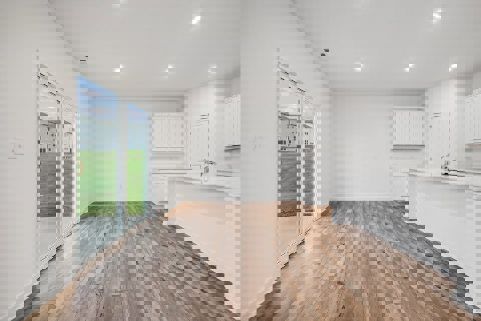 A kitchen with a wood floor.