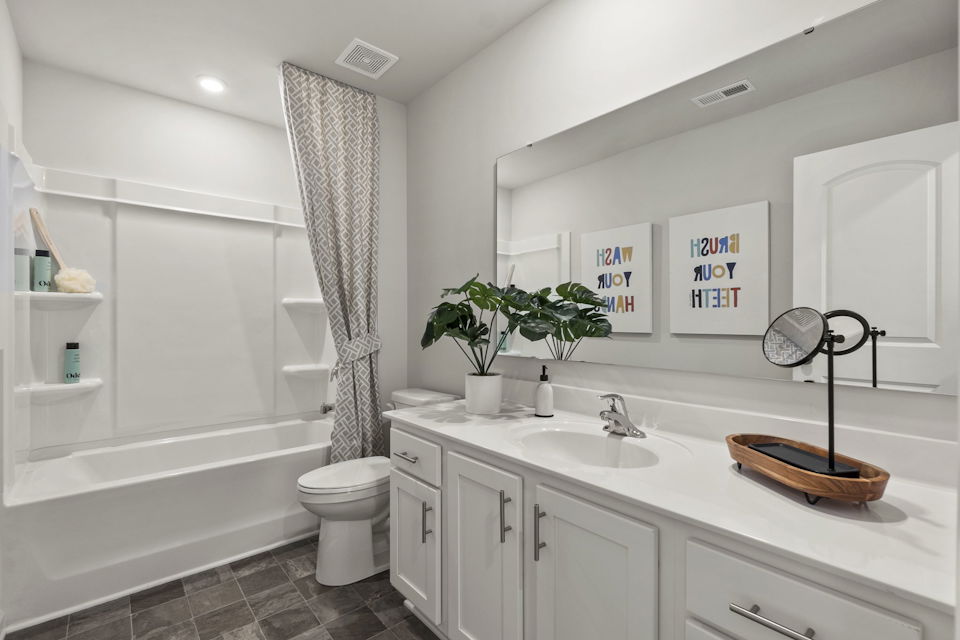 A bathroom with a tub sink and toilet.