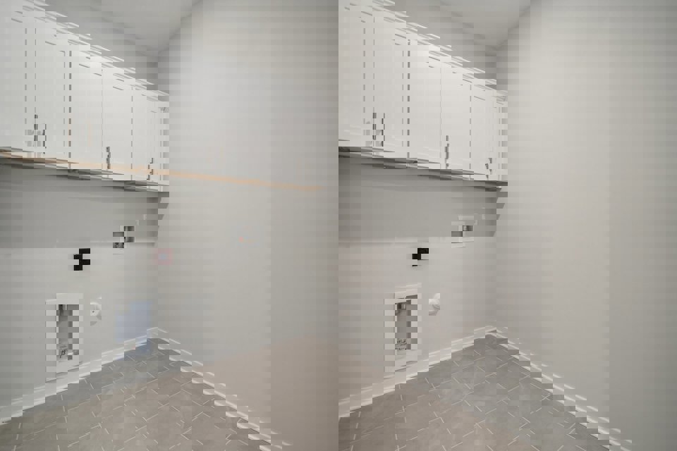 A white wall with white cabinets.