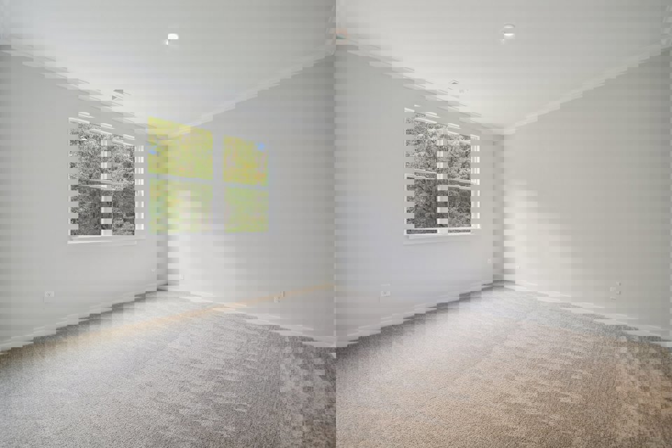 A room with a window and a carpet.