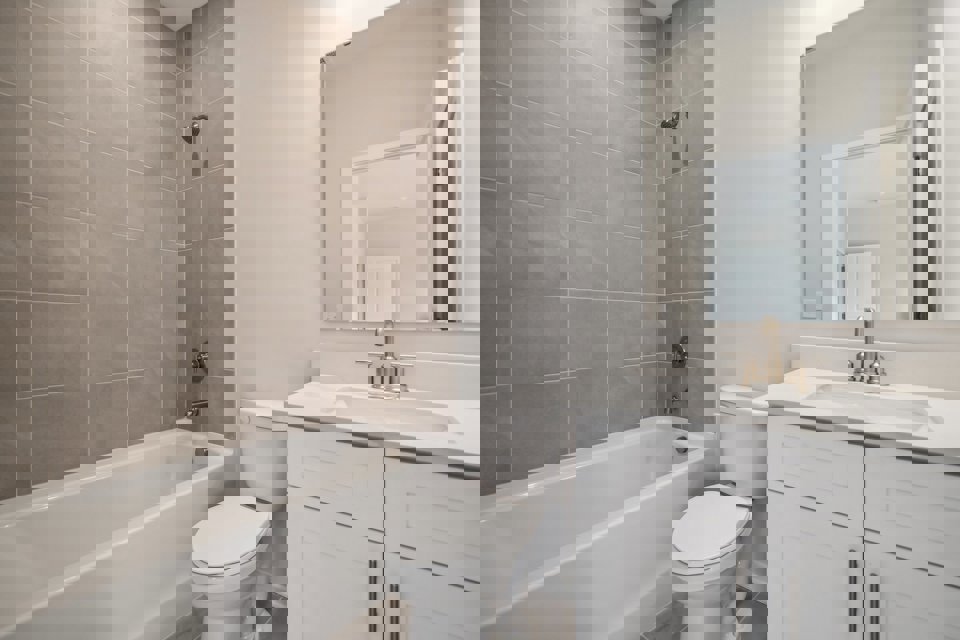 A bathroom with a tub sink and toilet.