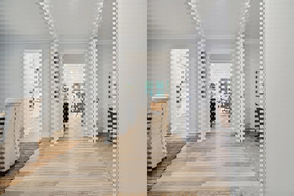 A room with a wood floor and a rug and a wood floor.